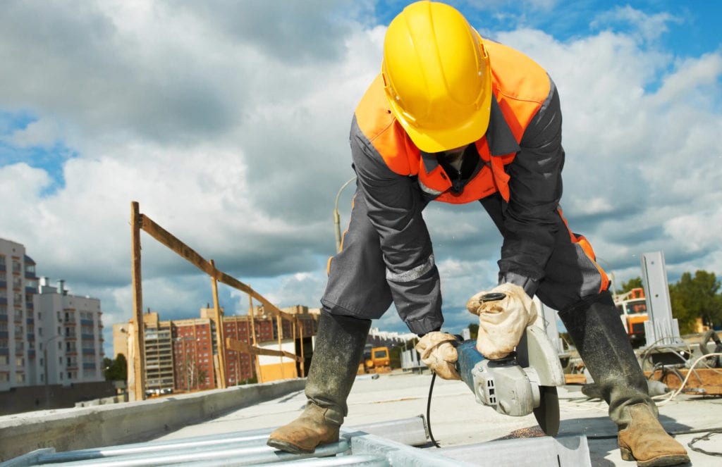 builder working with cutting grinder