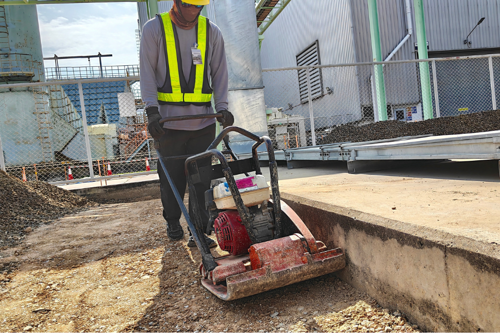 Plate Compactor being used by a worker